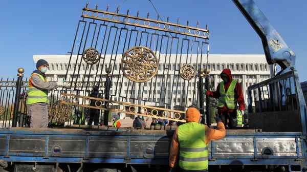 Workers remove a fence around Kyrgyzstan's house of parliament in Bishkek, which was&nbsp;stormed by protesters in October following the&nbsp;tainted parliamentary election.