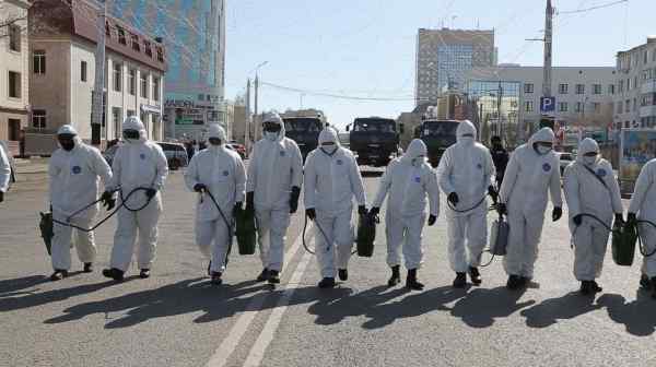 A Kazakh crew disinfects the streets of the capital, Nur-Sultan, on March 25. The country was the first to record COVID-19 cases in Central Asia.