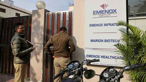 Police officers are&nbsp;seen outside a Marion Biotech office in Noida, India, on Dec. 29. Uzbekistan says 18&nbsp;children died after consuming the company's cough syrup.