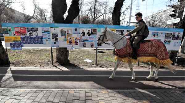 A man rides a horse past an election campaign&nbsp;board&nbsp;in Almaty,&nbsp;Kazakhstan on&nbsp;March 15.