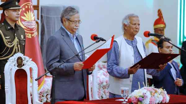 Bangladeshi President Mohammed Shahabuddin, center, swears in&nbsp;Muhammad Yunus, right, in Dhaka on Aug. 8: The interim government is&nbsp;a diverse, nonpartisan team of activists, academics and retired officials.&nbsp;