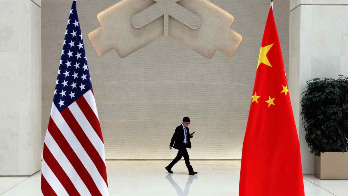 A man walks past U.S. and Chinese flags on the day of a meeting between U.S. Treasury Secretary Janet Yellen and People's Bank of China Gov. Pan Gongsheng in Beijing on April 8.