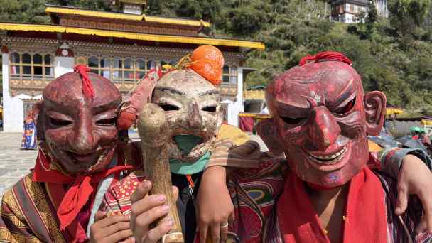 Masked performers show off a phallus used to ward off demons at a festival for the Chezhi Goenpa Temple in the Bhutanese village of Genekha. (All photos by Humphrey Hawksley)