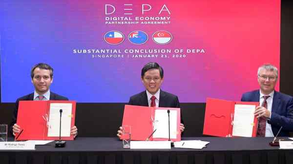 Chan Chun Sing, Singapore's minister for trade and industry, center, holds the signed joint statement for the Digital Economy Partnership Agreement with counterparts from New Zealand and Chile.