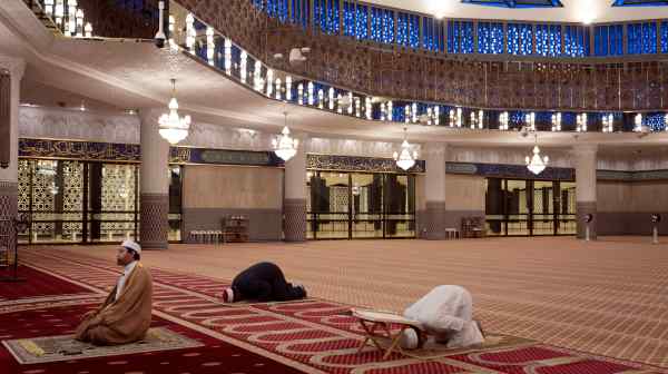 An imam, joined by just two mosque employees, leads the prayer at Kuala Lumpur&rsquo;s National Mosque on April 24.