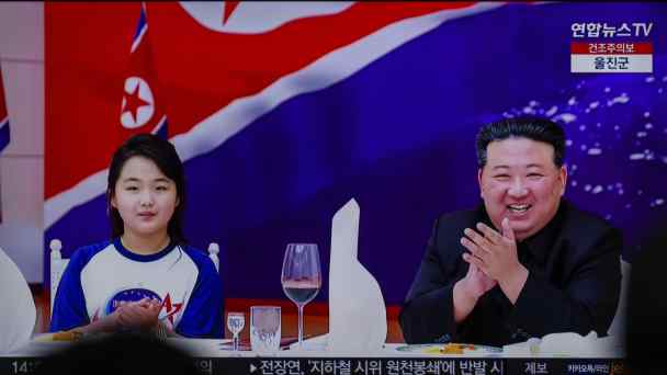 TV news at Seoul's Yongsan Railway Station shows North Korean leader Kim Jong Un and his daughter Kim Ju Ae, attending a banquet to celebrate the country's successful launch of a reconnaissance satellite.