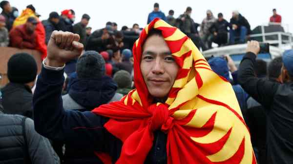 A demonstrator wears the&nbsp;Kyrgyzstan national flag&nbsp;during a protest against the results of a parliamentary election in the capital Bishkek on&nbsp;Oct. 6.