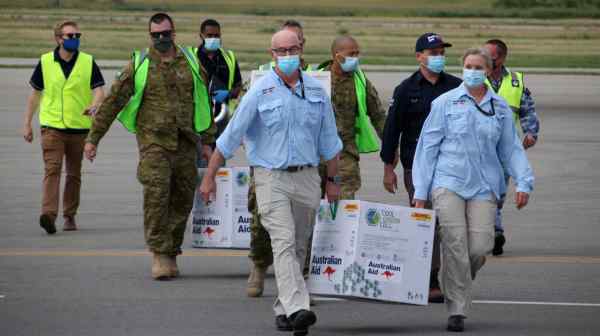 Australian officials deliver thousands of initial AstraZeneca vaccine doses to Port Moresby, Papua New Guinea, on March 23.