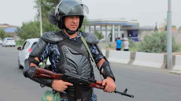 An Uzbek law enforcement officer guards a street in Nukus, the capital of the northwestern Karakalpakstan region, on July 3. Officials say 14 protesters and four officers were killed during recent unrest.