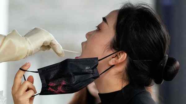 A woman gets swabbed to be&nbsp;tested for COVID-19 in Shanghai.&nbsp;Beginning on Jan. 5, all air passengers heading to the U.S., 2 years old and older, will require a negative result from a test no more than two days before departure from China, Hong Kong or Macao.