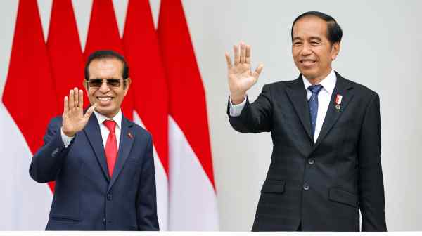 East Timor's Prime Minister Taur Matan Ruak, who is also a former East Timor independence fighter, and Indonesian President Joko Widodo wave to photographers as they meet at the Presidential Palace in Bogor, Indonesia, Feb. 13.