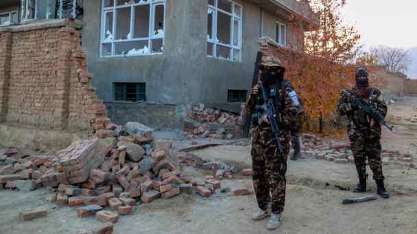 Afghanistan's ruling Taliban inspect the scene of an operation against Islamic State militants at a hideout on the outskirts of Kabul in November 2021.