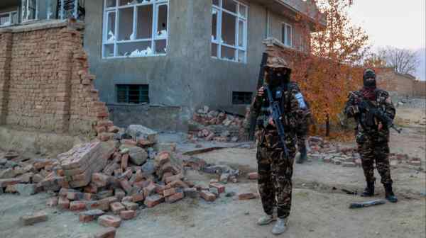 Afghanistan's ruling Taliban inspect the scene of an operation against Islamic State militants at a hideout on the outskirts of Kabul in November 2021.