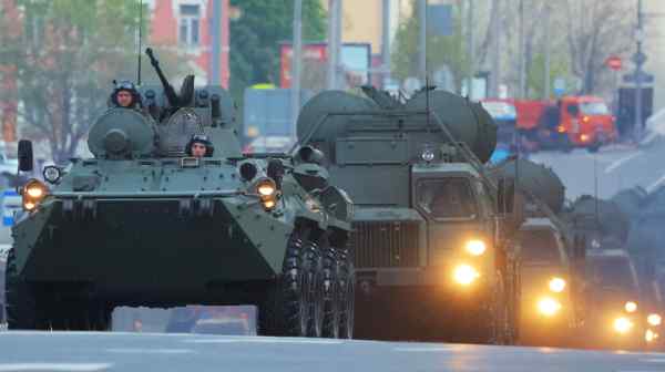 Russian service members drive armored vehicles before a military parade rehearsal in Moscow in April.&nbsp;