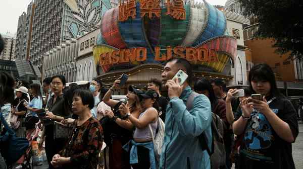 Visitors gather at the Casino Lisboa in Macao. The operator, SJM Holdings, narrowed its losses during&nbsp;the first half.