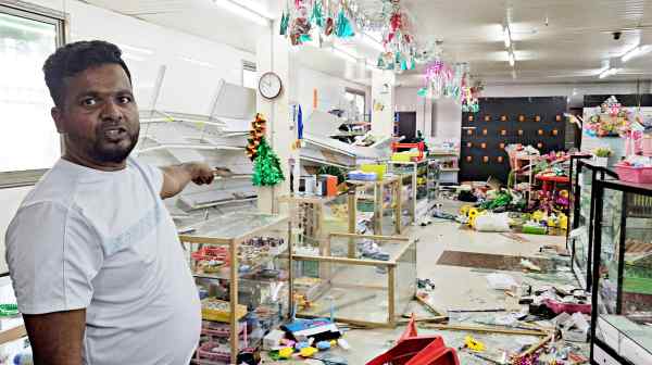 A man shows the damage on Jan. 11 after looters tore through a shopping center in Port Moresby. The riots began after police walked off the job over a pay dispute.