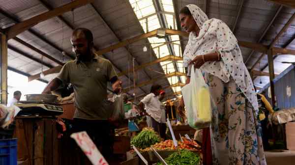 A woman buys vegetables at a market in Colombo in November 2023. Sri Lanka is relying on international support as it recovers&nbsp;from a deep economic crisis.