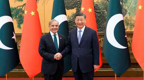 Chinese President Xi Jinping, right,&nbsp;and Pakistani Prime Minister Shehbaz Sharif greet each other at the Great Hall of the People in Beijing on June 7.