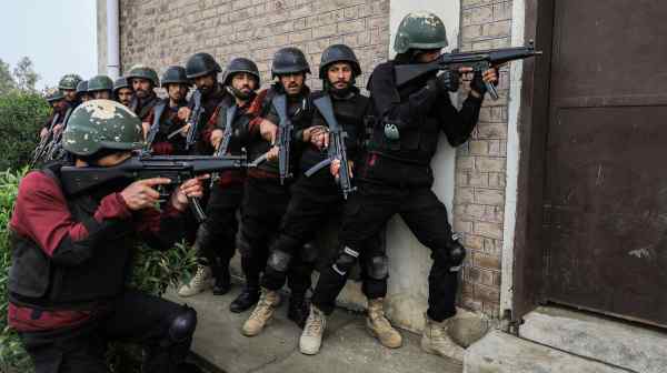 Pakistani police officers&nbsp;take position during a counterterrorism training session.