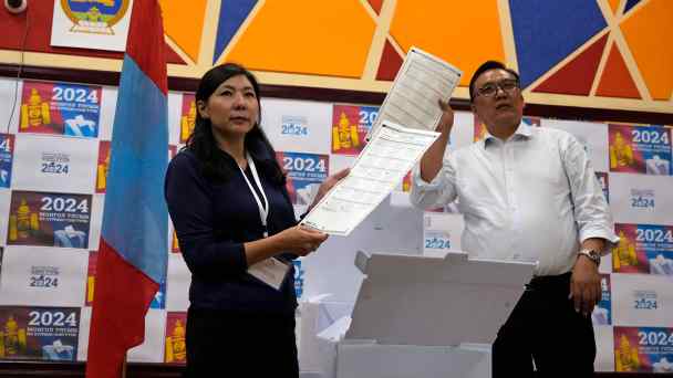 Election workers hold&nbsp;up ballots as manual counting begins in Ulaanbaatar, Mongolia, in the early hours of June 29.