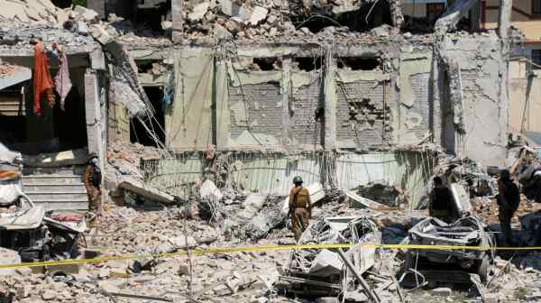 Army soldiers stand amid the rubble, a day after explosions in the counter-terrorism office building in a town in Swat, Pakistan, in April 2023.&nbsp;