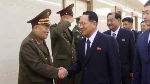 A North Korean general, left, greets the president of Kim Il Sung Military University, Kim Kum Chol, as his delegation&nbsp;leaves&nbsp;Pyongyang airport on&nbsp;July 8. (AP Photo/Cha Song Ho)