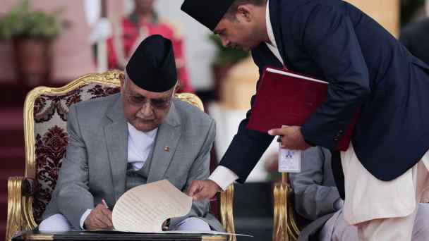 Newly appointed Prime Minister KP Sharma Oli signs a document after taking the oath of office at the Shital Niwas presidential building&nbsp;in Kathmandu on&nbsp;July 15.