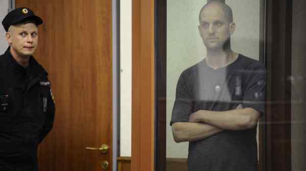 Wall Street Journal reporter&nbsp;Evan&nbsp;Gershkovich, arrested in Russia on charges of espionage, stands inside an enclosure for defendants during a court hearing in Yekaterinburg on July 19.