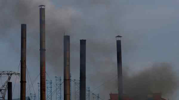 Smoke rises from the chimney of a paper factory outside Hanoi, Vietnam, in May 2018.