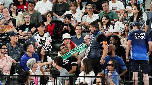 A security staff member confiscates a towel with the word "Taiwan" on it at Porte de La Chapelle Arena in Paris on&nbsp;Aug. 2.