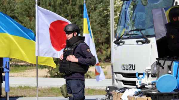 A rescuer stands by trucks equipped with cranes conveyed by the Japan International Cooperation Agency&nbsp;to the State Emergency Service of Ukraine&nbsp;in the Kyiv region of northern Ukraine, on April 25, 2023.