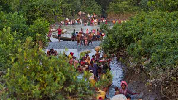 Groups of Rohingya cross the Naf River near Palong Khali, Bangladesh, in 2017.