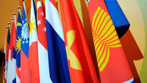 Flags of ASEAN member nations are seen. Japan aims to counter Chinese influence in the region.