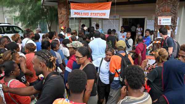 Voters wait for a polling station to open to vote during the Solomon Islands elections in the capital Honiara on April 17.