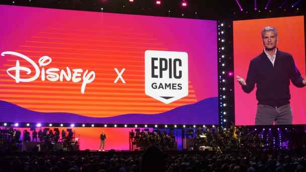 A spokesperson explains the tie-up between Walt Disney and Epic Games during the D23 fan event in Anaheim, California, on Aug. 10. Disney has invested $1.5 billion in Epic Games and licenses special edition character costumes and items for the online game&nbsp;Fortnite. (Photo by Rei Nakafuji)