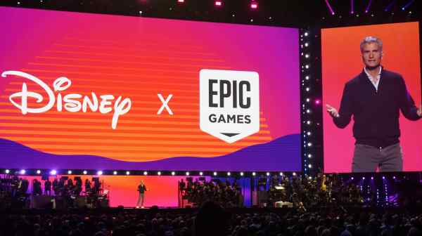 A spokesperson explains the tie-up between Walt Disney and Epic Games during the D23 fan event in Anaheim, California, on Aug. 10. Disney has invested $1.5 billion in Epic Games and licenses special edition character costumes and items for the online game&nbsp;Fortnite. (Photo by Rei Nakafuji)