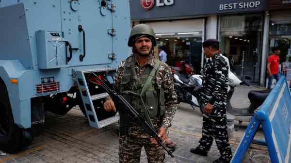 An Indian security member stands guard on a Srinagar street in the Jammu and Kashmir region ahead of the Muslim festival of Eid al-Adha on June 16.