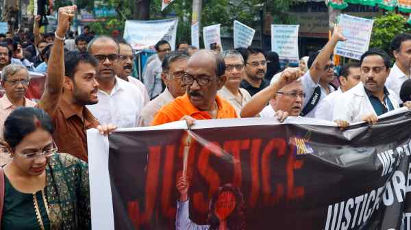 Doctors march along a street during a protest condemning the rape and murder of a trainee medic at a government-run hospital, in Kolkata on Aug. 17.