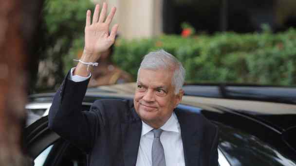 President Ranil Wickremesinghe gestures as he arrives at the Election Commission on Aug.15 in Colombo to submit his nomination papers for the upcoming presidential election.