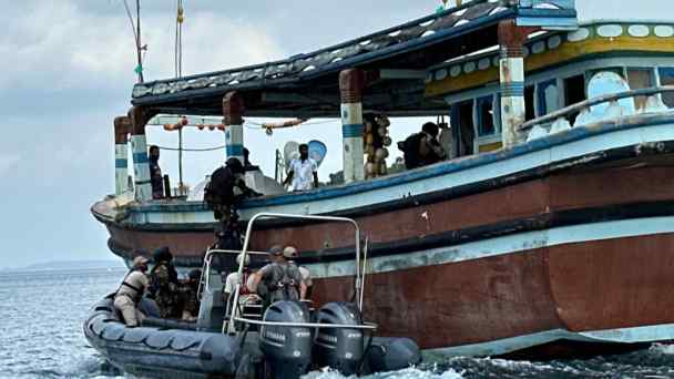 Members of the Sri Lankan military board a smuggling ship as part of a training exercise on maritime crime near Trincomalee. (Photo by Takayuki Tanaka)