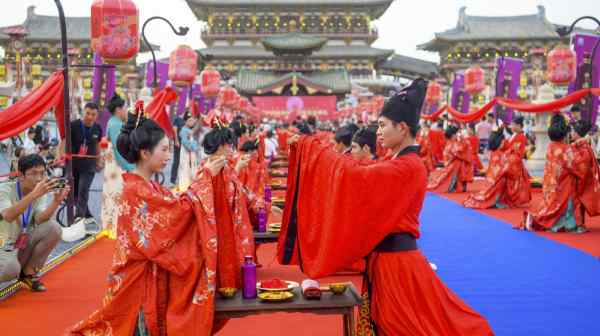 Couples wearing traditional Han Chinese clothing participate in a marriage event in Luoyang, China, on Aug. 10.