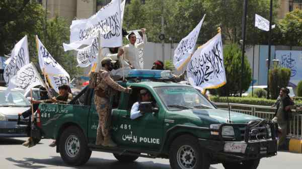 Taliban fighters in Kabul celebrate the third anniversary of the withdrawal of U.S.-led troops from Afghanistan on Aug. 14.