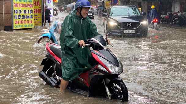 Frequent disasters encourage Southeast Asians&nbsp;to prepare. A man drives a motorbike in a&nbsp;flooded street after heavy rains in Hanoi,&nbsp;Vietnam, in September 2023.