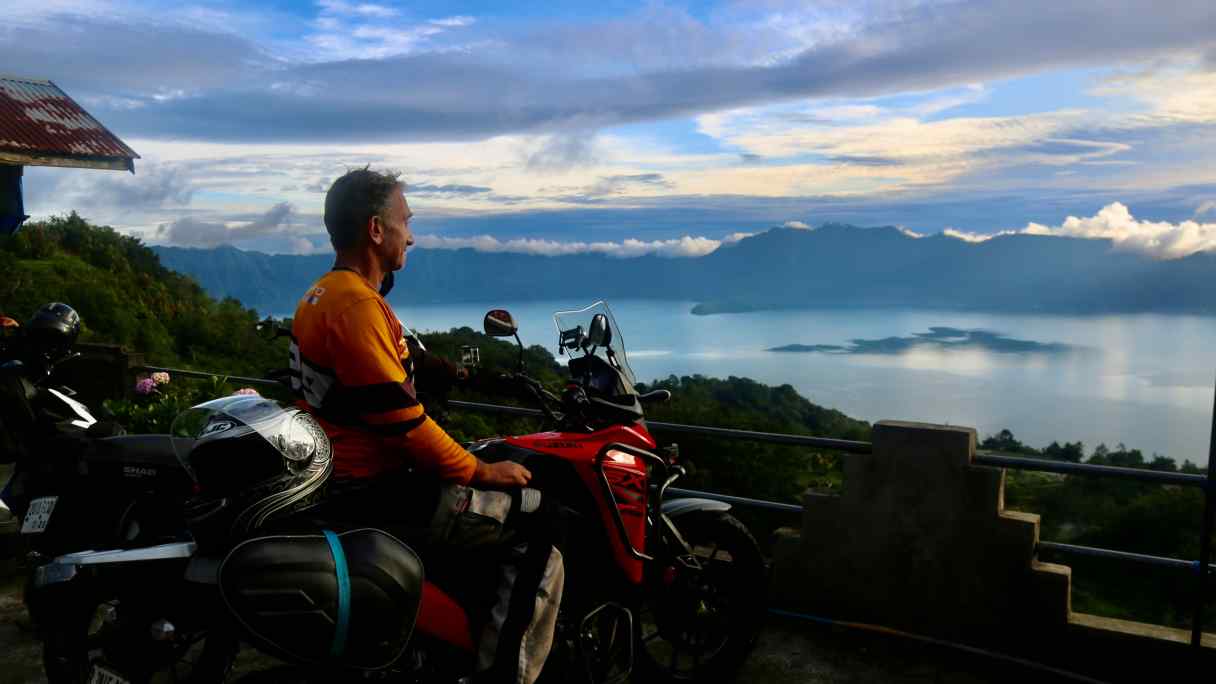 The author on his latest adventure, a 3,000-kilometer&nbsp;ride through Sumatra, the largest island fully inside Indonesian territory. This photo was taken at sunset at a viewpoint overlooking Lake Maninjau in West Sumatra province.&nbsp;(All photos courtesy of Ian Lloyd Neubauer)