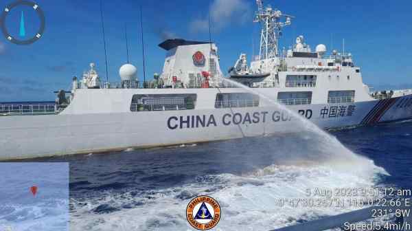 A Chinese coast guard ship uses water canons on a Philippine Coast Guard ship near the Philippine-occupied Second Thomas Shoal, South China Sea as they blocked it's path during a re-supply mission on Aug. 5, 2023. (Philippine Coast Guard via AP)