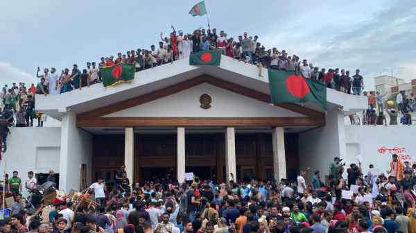 Protesters gather around the prime minister's residence in Bangladesh as demonstrations sweep Dhaka on Aug. 5.