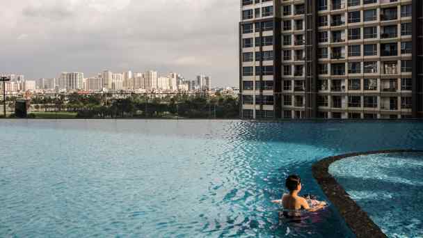 A boy swims in a pool at a Vinhomes condominium complex in Ho Chi Minh City: Demand for housing in&nbsp;Vietnam's big cities outstrips supply, buoying prices.